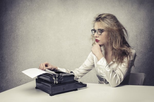 A lady sits at a typewriter creating groundbreaking pornographic films